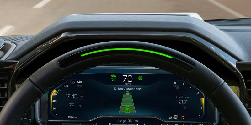 Close-up of a car's digital dashboard displaying driver assistance features