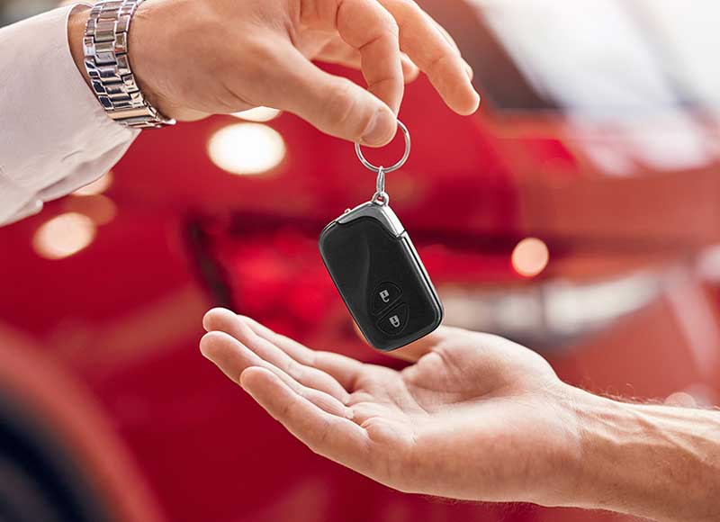salesman passing key to customer
